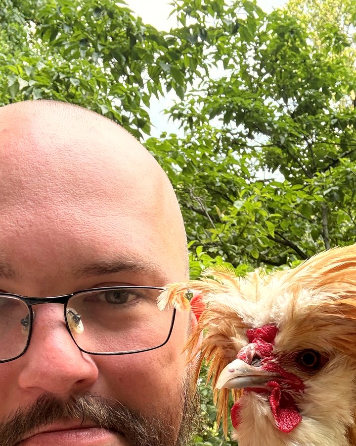Jake with Coco the Polish rooster perched on his shoulder