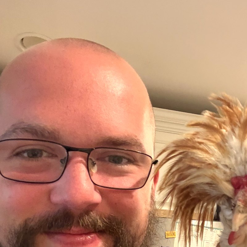 Jake smiling, with Coco's feather crest photobombing the shot